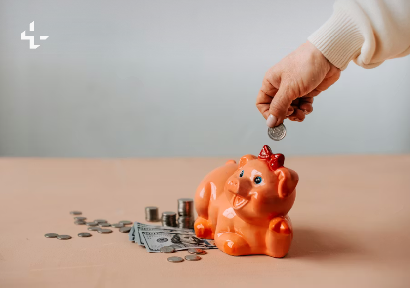Plant growing from a stack of coins, representing savings growth